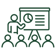 Classroom Icon with instructor pointing at a a chart and a row of people watching in the audience